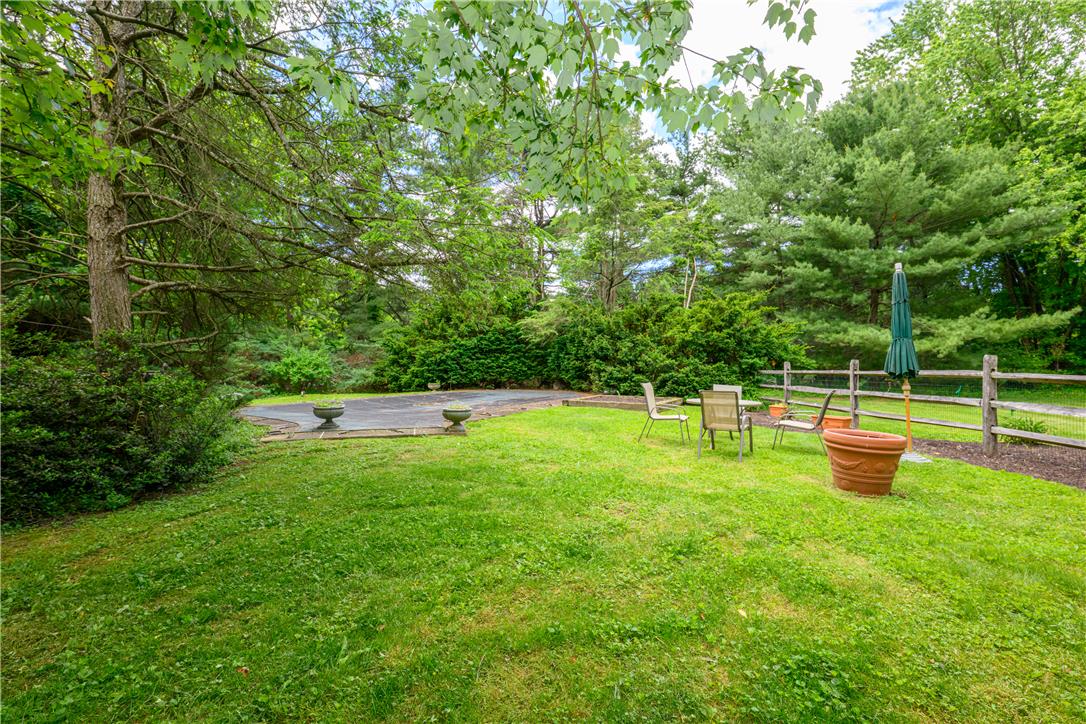 2516 Rachael Lane Orefield, PA 18069 - Photo 35 of 45 A spacious yard with mature trees and a fenced boundary, offering privacy and outdoor living.