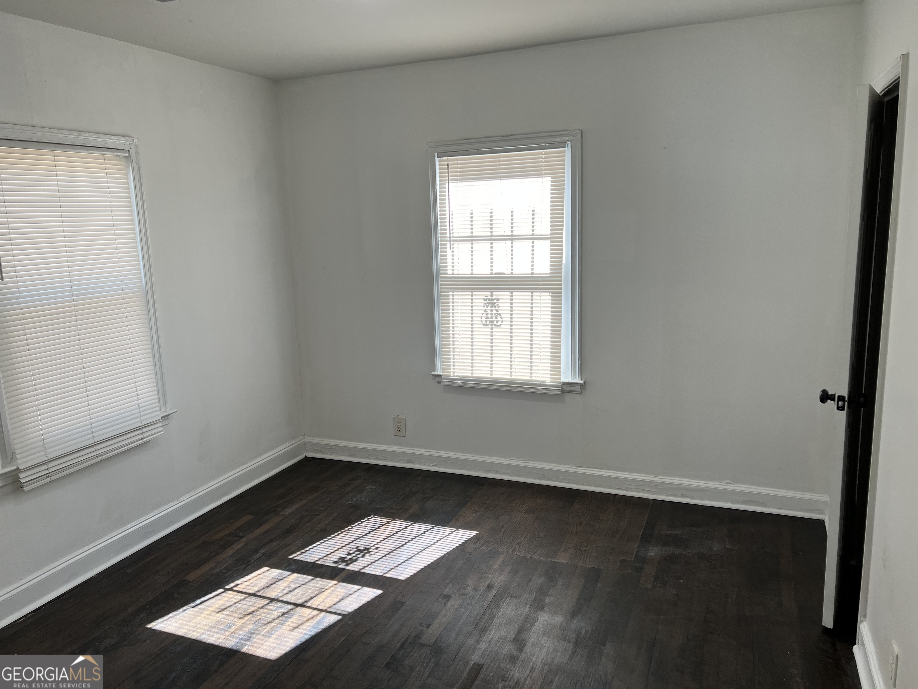 2158 Beecher Road Southwest, Unit A Atlanta, GA 30311 - Photo 12 of 20 an empty room with wooden floor and windows
