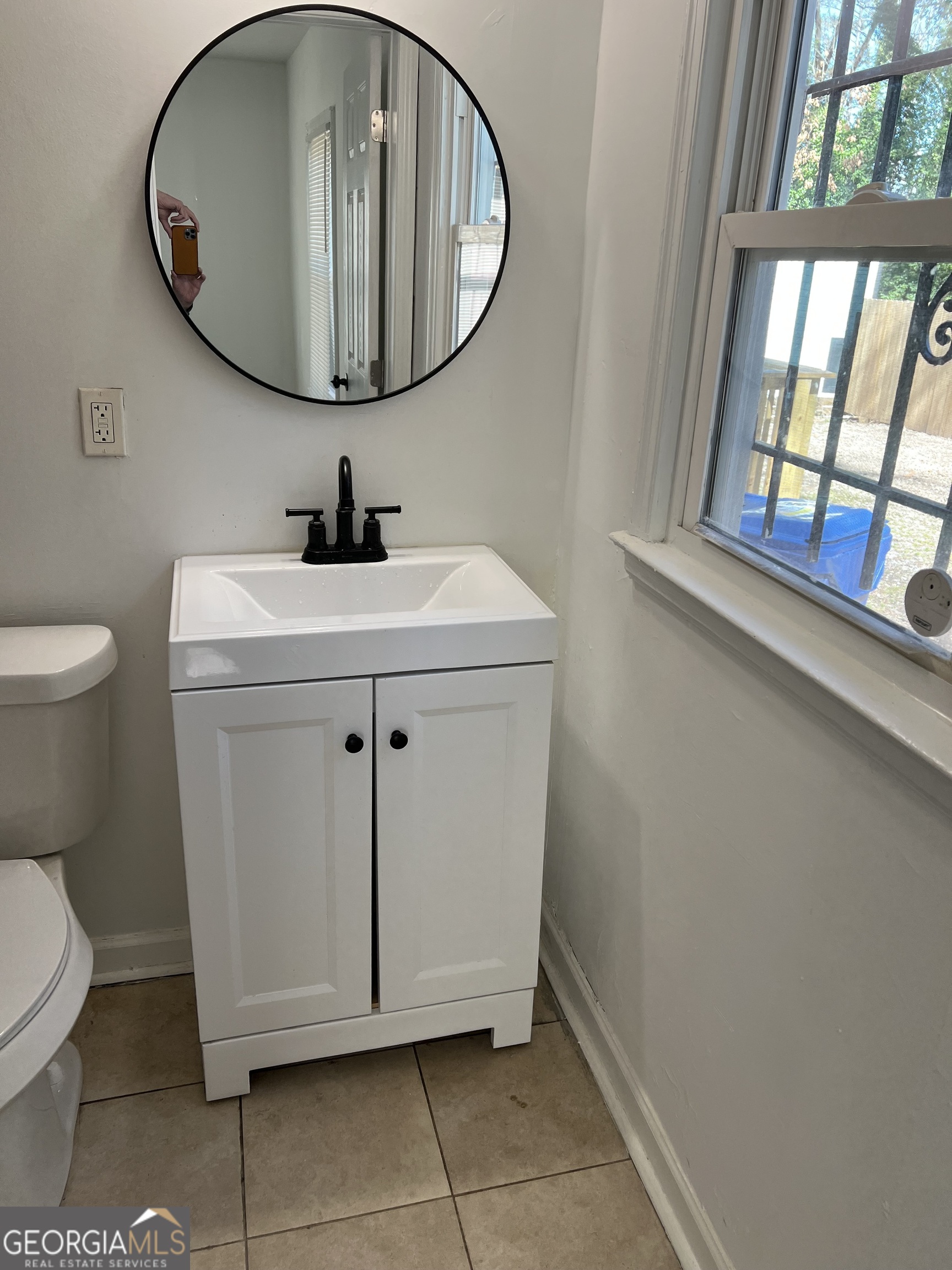 2158 Beecher Road Southwest, Unit A Atlanta, GA 30311 - Photo 14 of 20 a bathroom with a sink a mirror and a toilet
