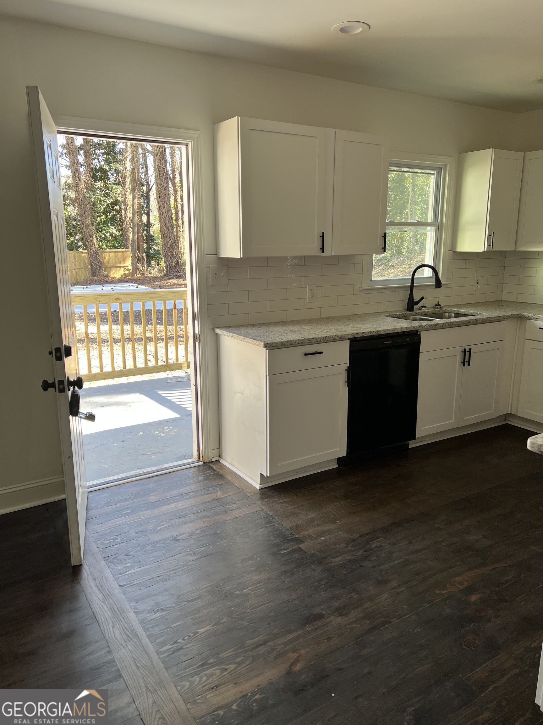2158 Beecher Road Southwest, Unit A Atlanta, GA 30311 - Photo 19 of 20 a kitchen with granite countertop a stove a sink and a microwave