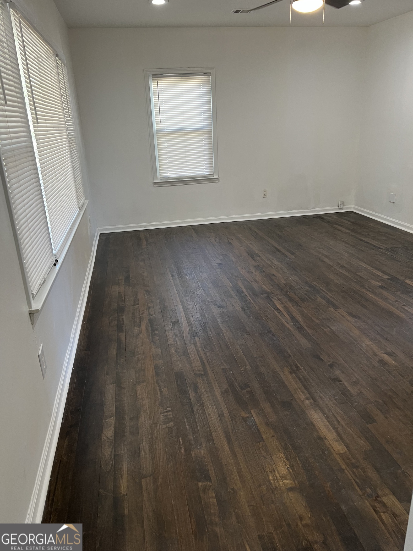 2158 Beecher Road Southwest, Unit A Atlanta, GA 30311 - Photo 4 of 20 an empty room with wooden floor and windows