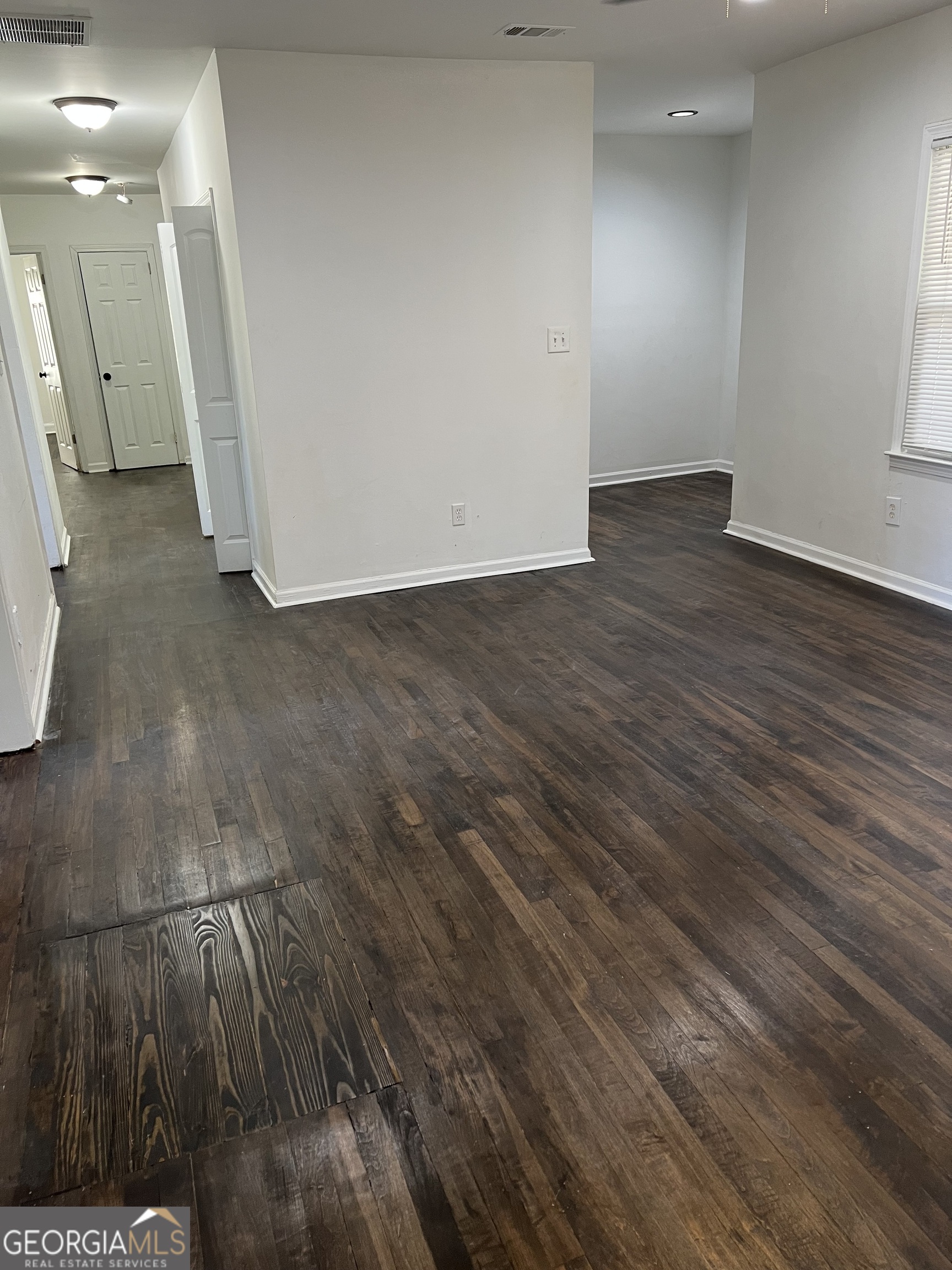 2158 Beecher Road Southwest, Unit A Atlanta, GA 30311 - Photo 5 of 20 an empty room with wooden floor and windows