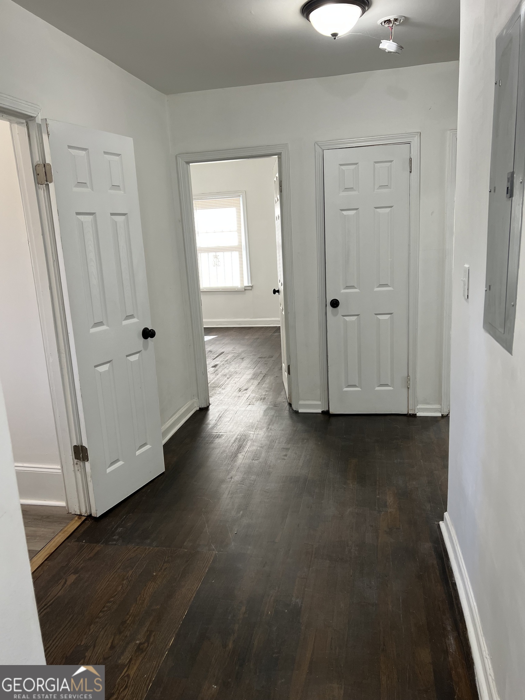 2158 Beecher Road Southwest, Unit A Atlanta, GA 30311 - Photo 10 of 20 an empty room with wooden floor and windows