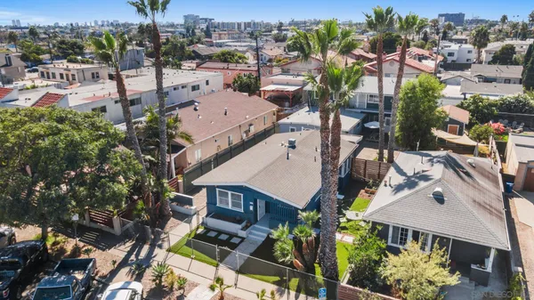 an aerial view of a house with a yard and lake view