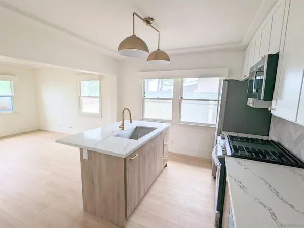 a kitchen with a sink stove and refrigerator