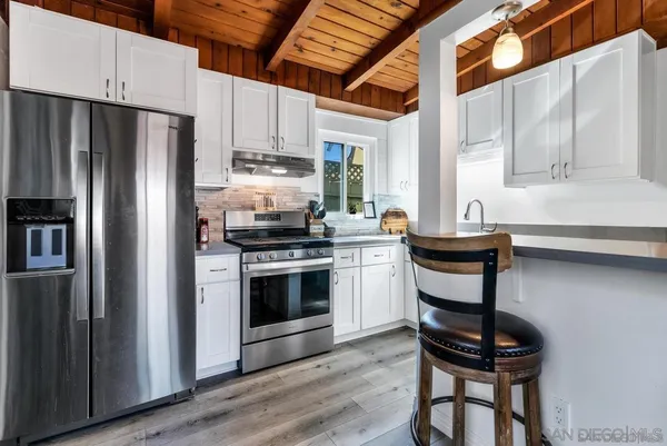 a kitchen with stainless steel appliances a stove a sink and a refrigerator