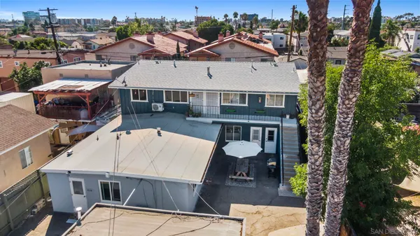 an aerial view of a house with wooden floor and city view