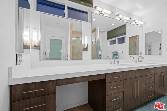 a bathroom with a sink vanity and a mirror