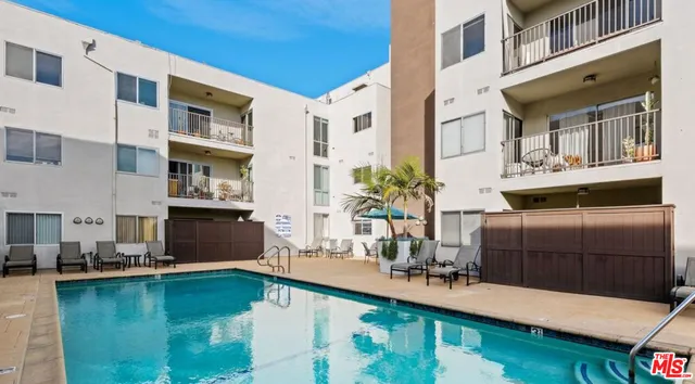 a swimming pool view with a outdoor seating space