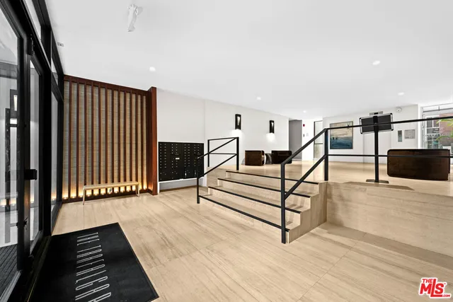 a view of a livingroom with furniture and stairs