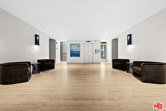 a view of a living room with furniture and wooden floor
