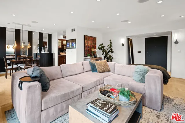 a living room with furniture and kitchen view