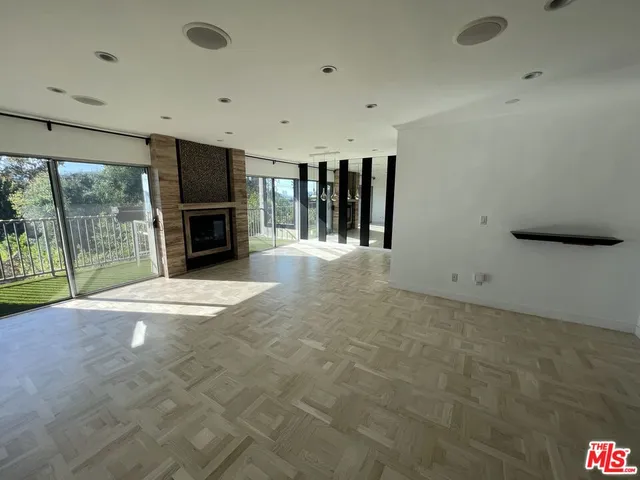 a view of an empty room with a fireplace