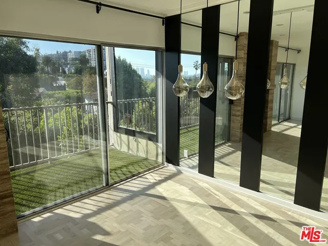 a bedroom with a bed and glass door