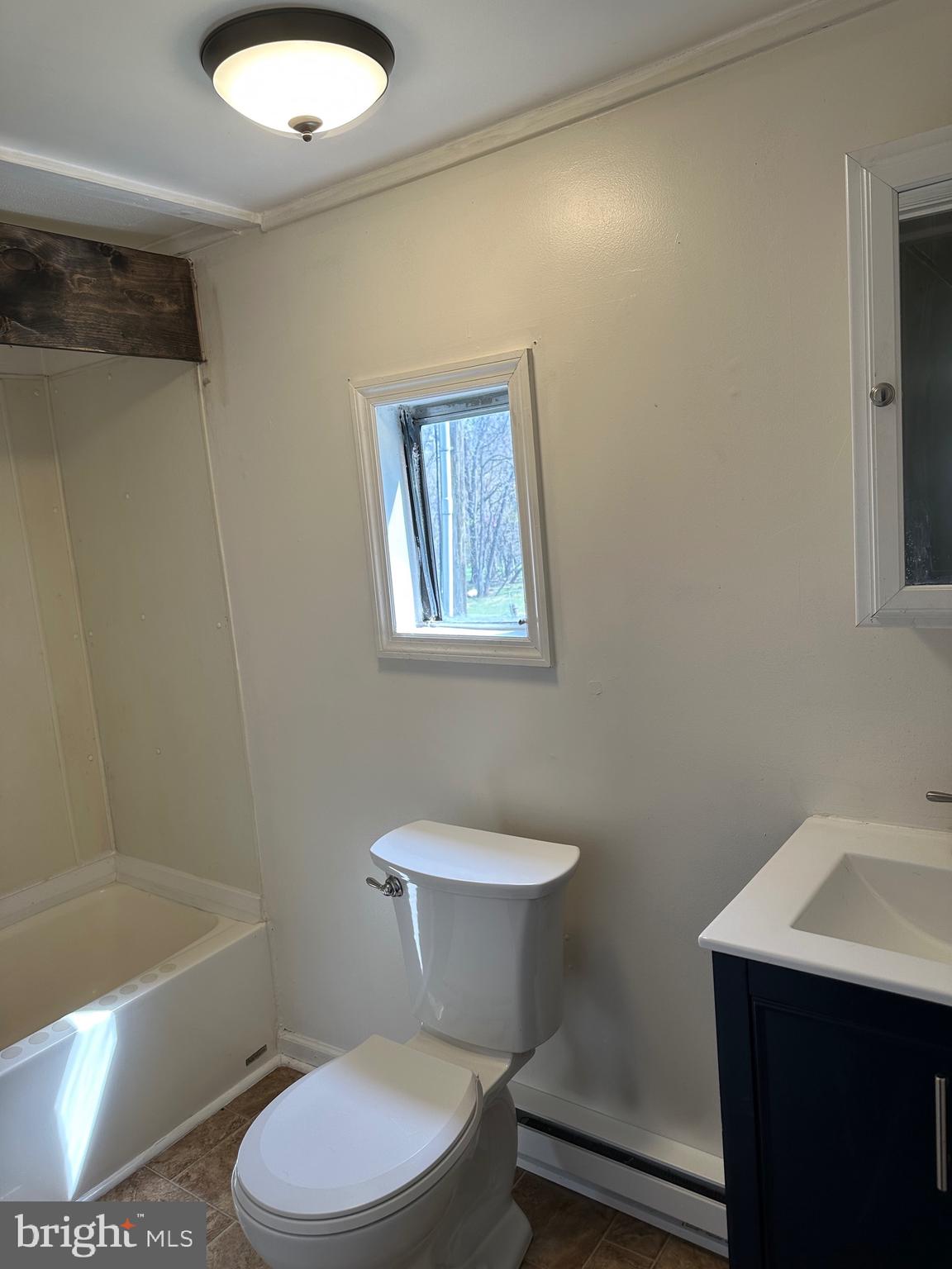 2084 Silvers Road Berkeley Springs, WV 25411 - Photo 12 of 31 a bathroom with a toilet a sink and bathtub