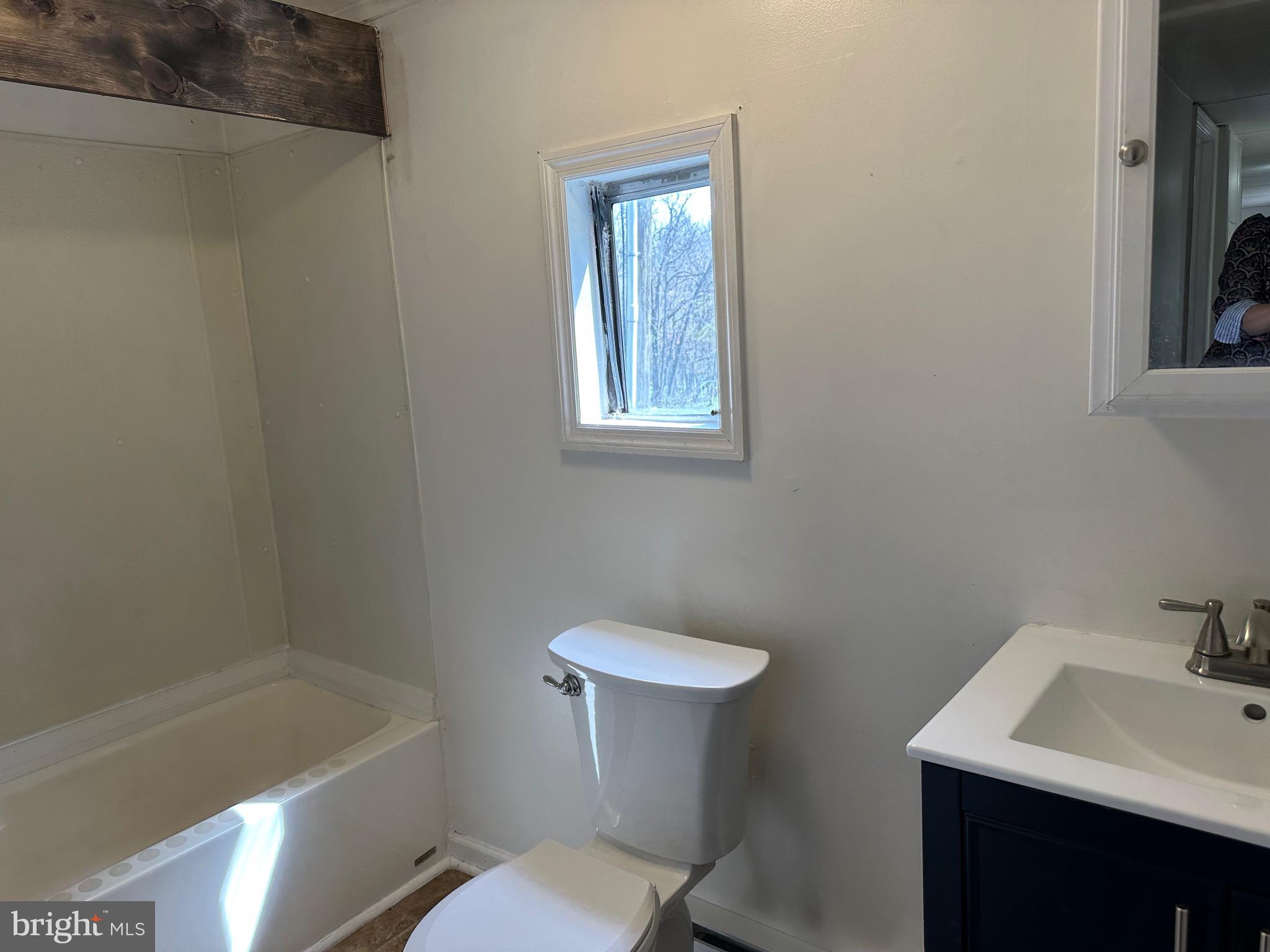 2084 Silvers Road Berkeley Springs, WV 25411 - Photo 13 of 31 a bathroom with a sink a toilet and shower