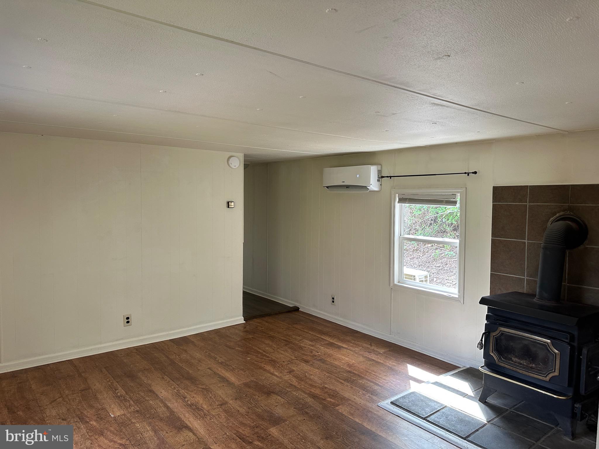 2084 Silvers Road Berkeley Springs, WV 25411 - Photo 5 of 31 a view of empty room with wooden floor and fan