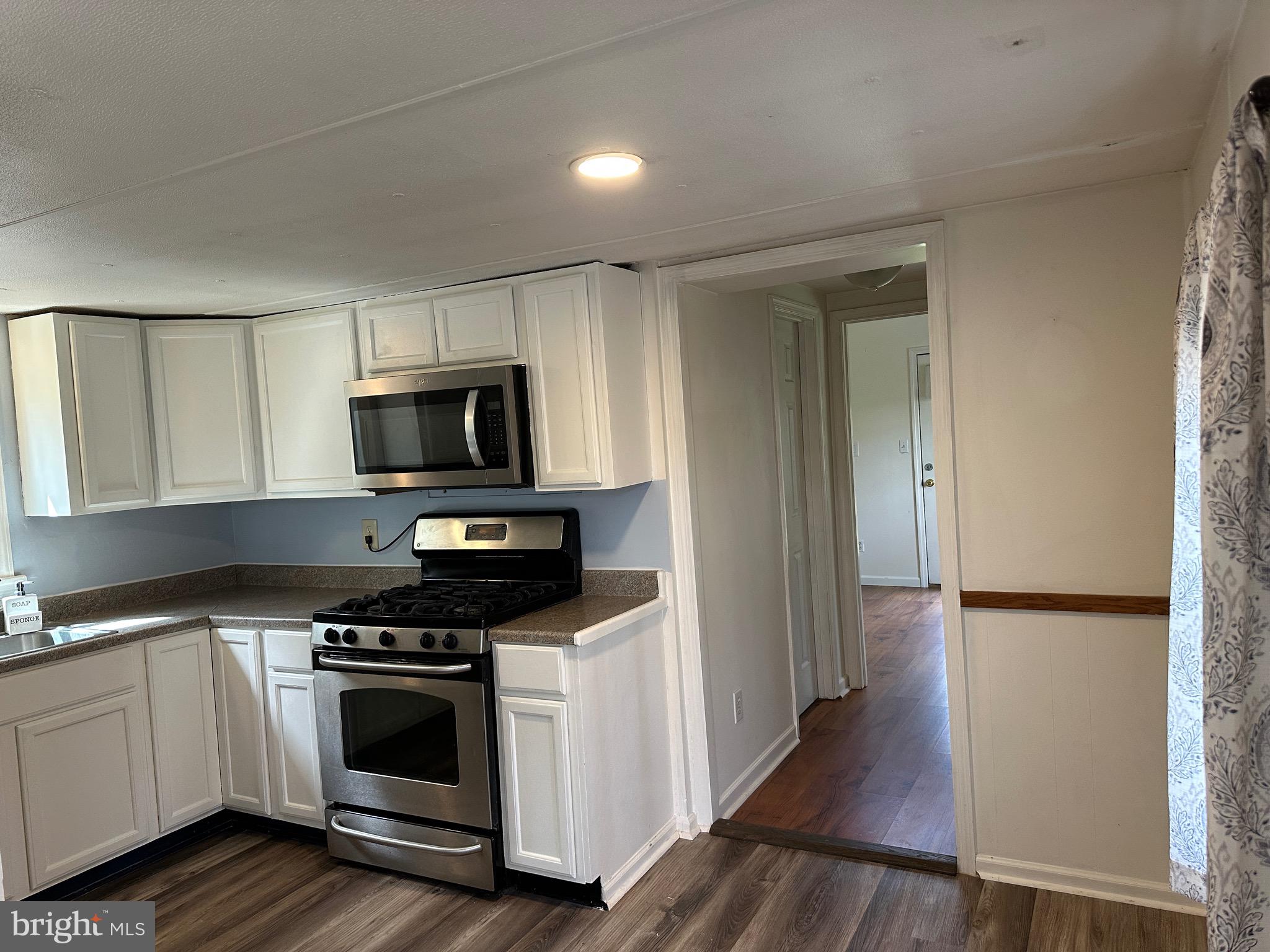 2084 Silvers Road Berkeley Springs, WV 25411 - Photo 7 of 31 a kitchen with stove cabinets and microwave