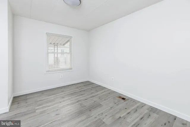 a view of a kitchen with a sink cabinets and wooden floor