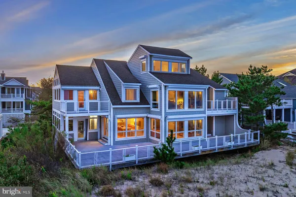 a view of a house with a backyard and porch