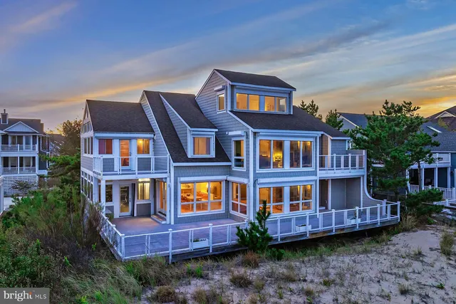 a view of a house with a backyard and porch