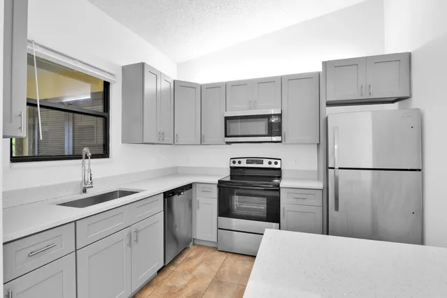 a kitchen with a refrigerator sink and microwave