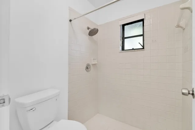 a white toilet sitting next to a bathroom sink