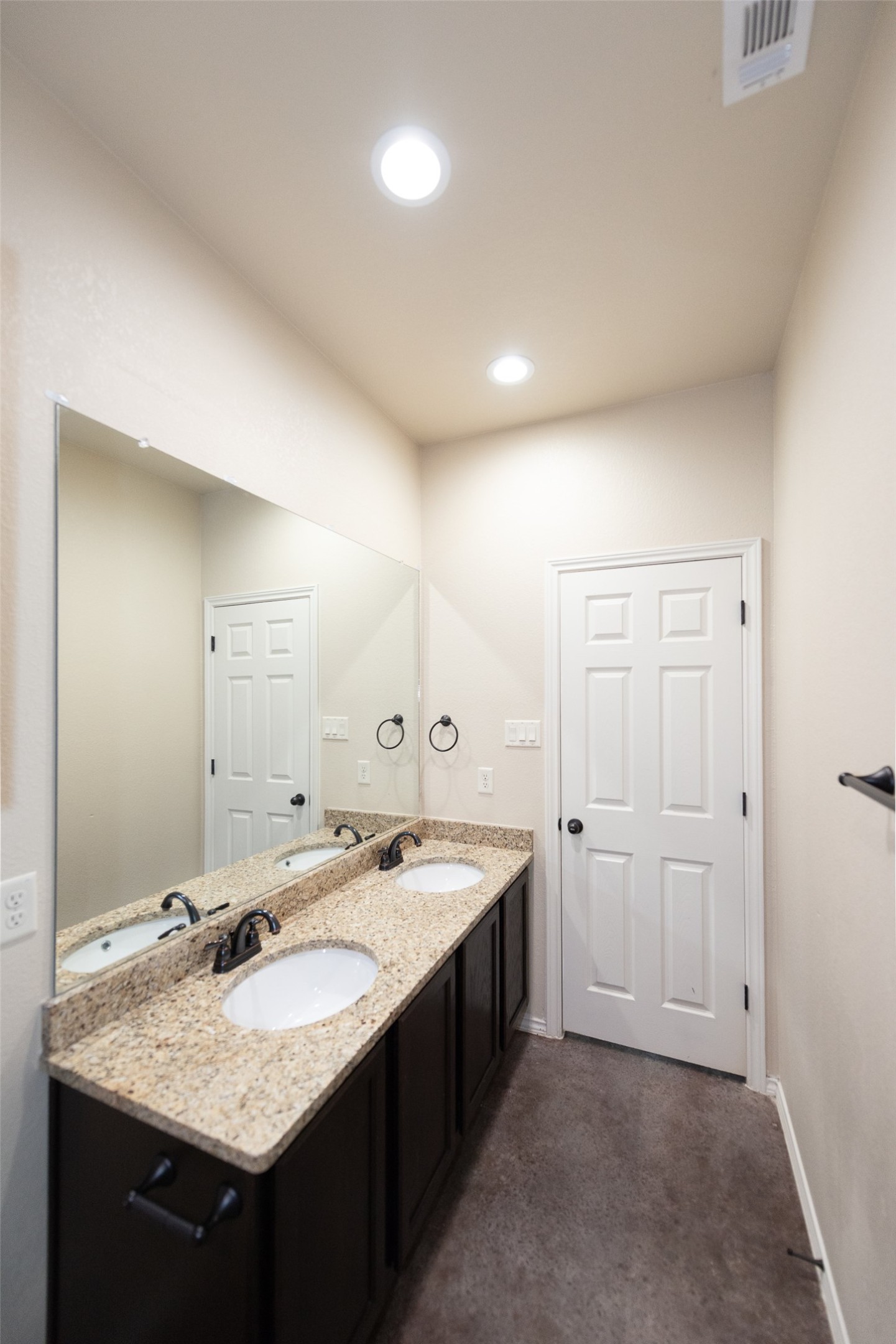 245 Joanne Loop, Unit B Buda, TX 78610 - Photo 26 of 33 Looking back at primary bath entry from shower. Primary Bathroom, fully tiled shower, dual vanity, granite counters and recessed lighting