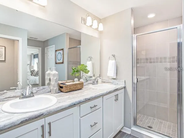 a bathroom with a granite countertop sink a toilet and a bathtub
