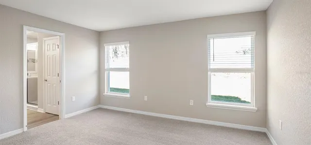 a view of walk in closet with empty racks