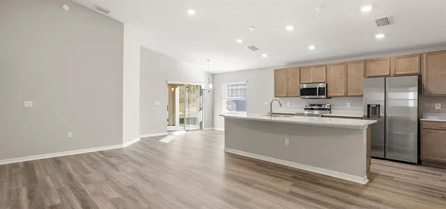 a kitchen with a sink appliances and cabinets