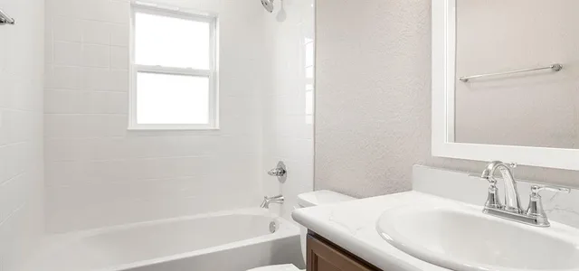 a kitchen with a sink and wooden floor