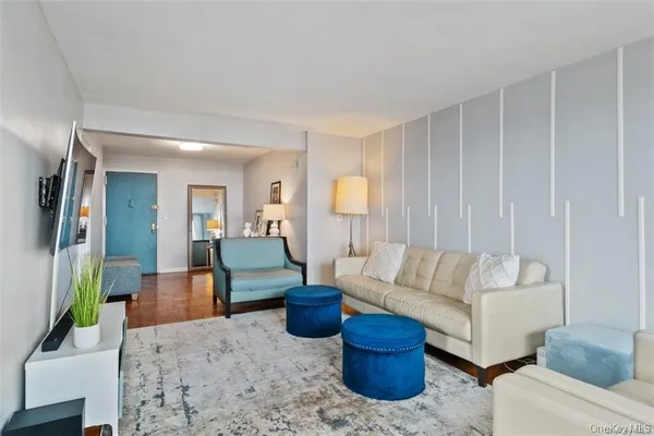a living room with furniture and a potted plant