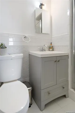a white toilet sitting next to a bathroom sink