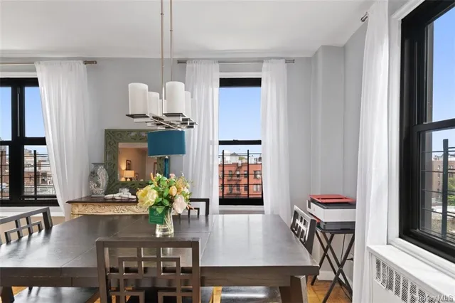 a kitchen with a table chairs refrigerator and stove
