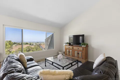 a living room with furniture plant and a window