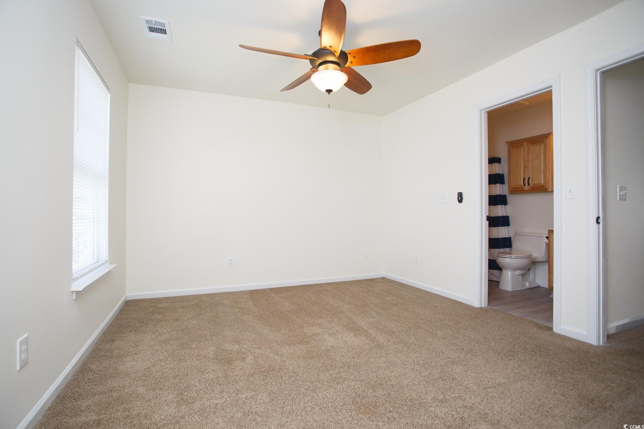 116 Barnacle Lane, Unit 1 Little River, SC 29566 - Photo 17 of 27 Unfurnished room with light colored carpet and a ceiling fan