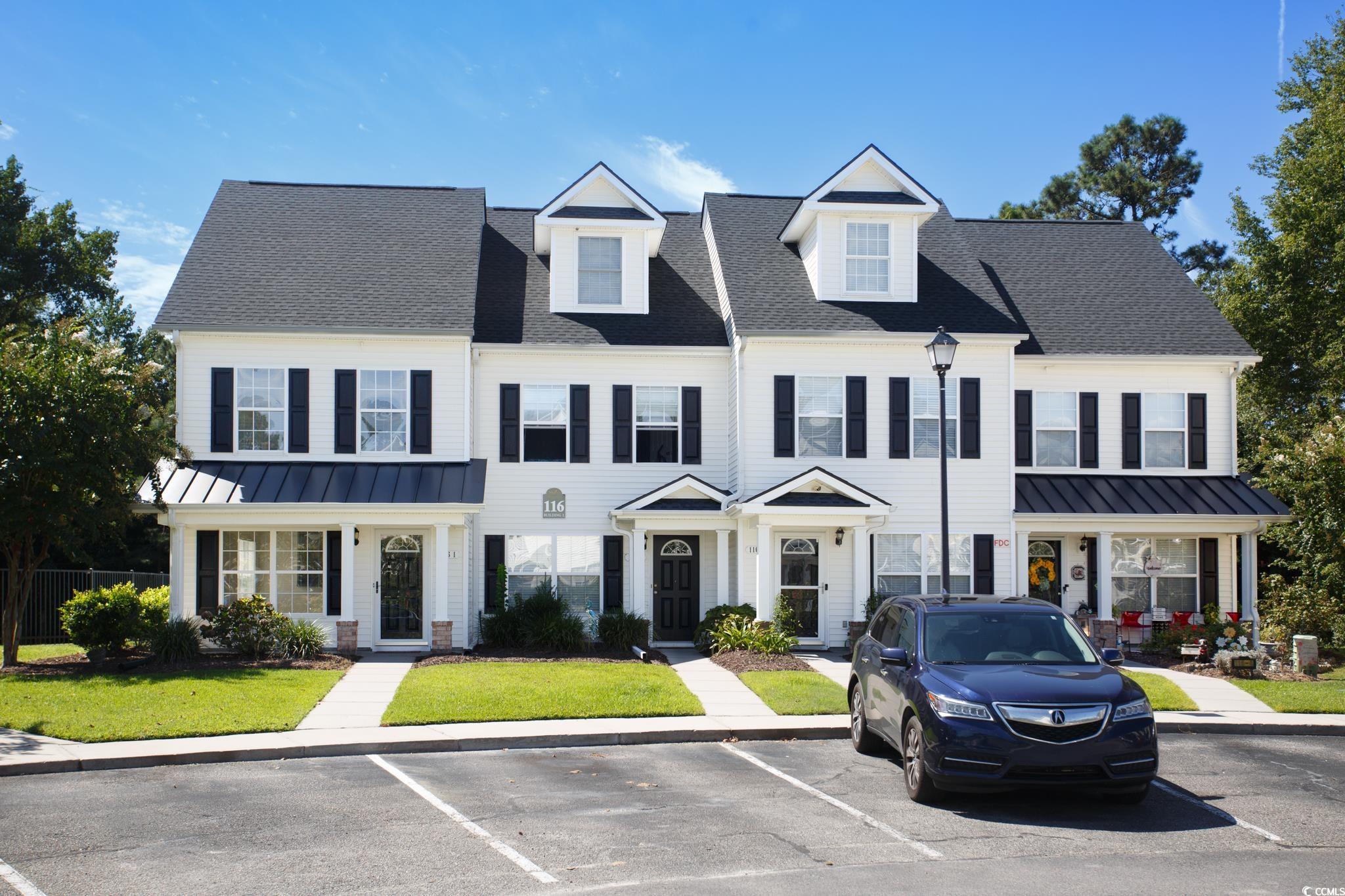 116 Barnacle Lane, Unit 1 Little River, SC 29566 - Photo 2 of 27 View of front of home featuring a standing seam roof, a metal roof, and uncovered parking