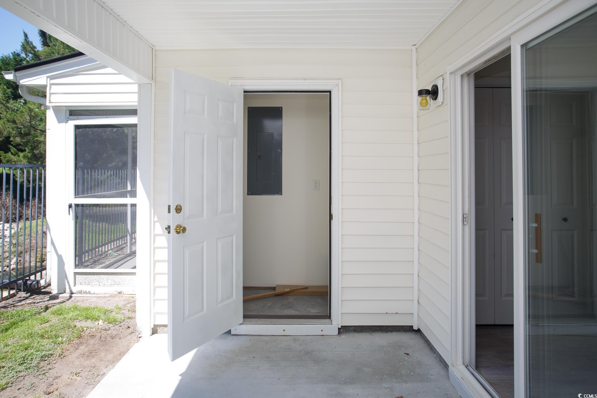 116 Barnacle Lane, Unit 1 Little River, SC 29566 - Photo 21 of 27 View of exterior entry featuring electric panel