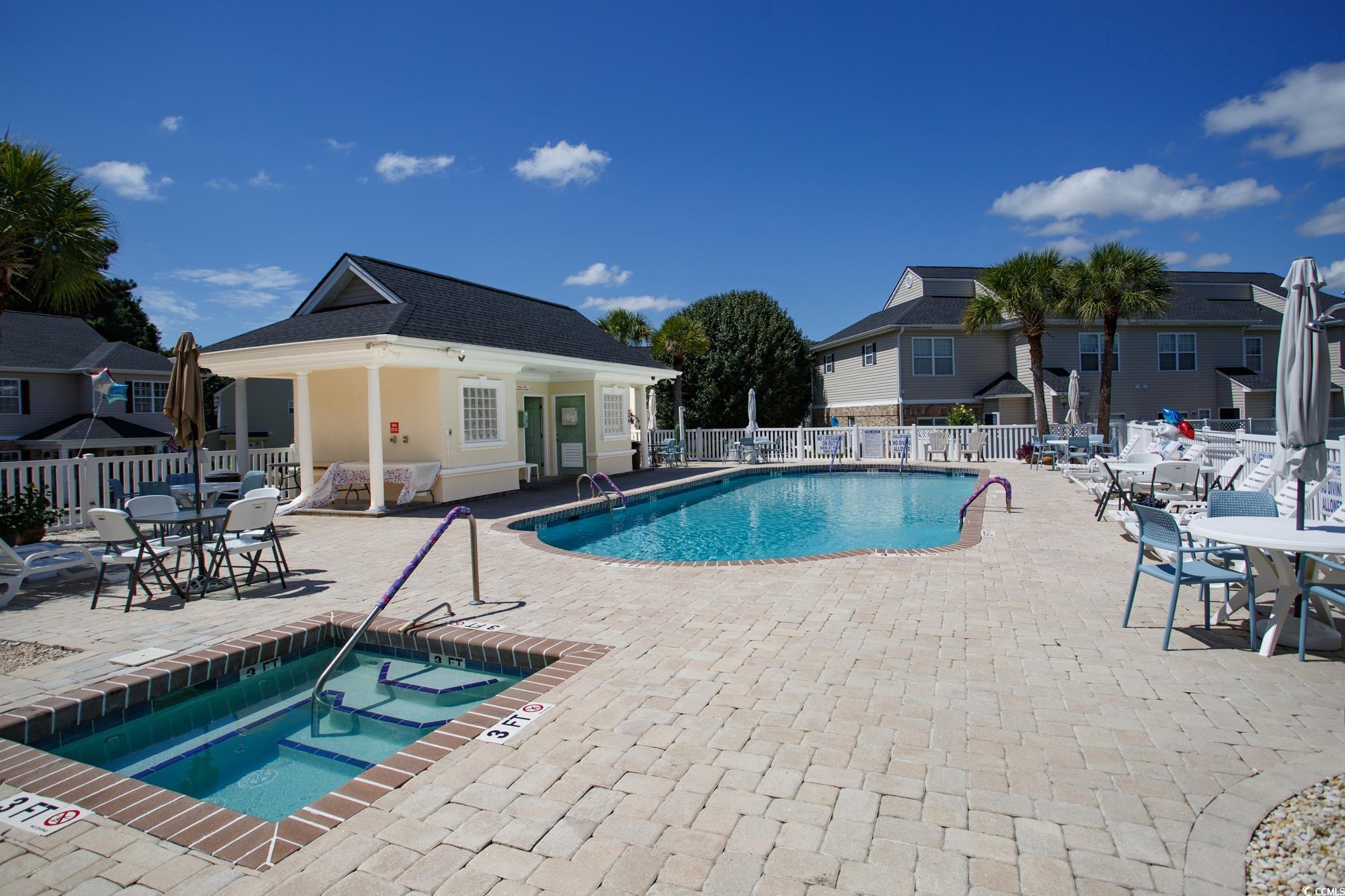 116 Barnacle Lane, Unit 1 Little River, SC 29566 - Photo 26 of 27 Community pool with a patio area and a community hot tub