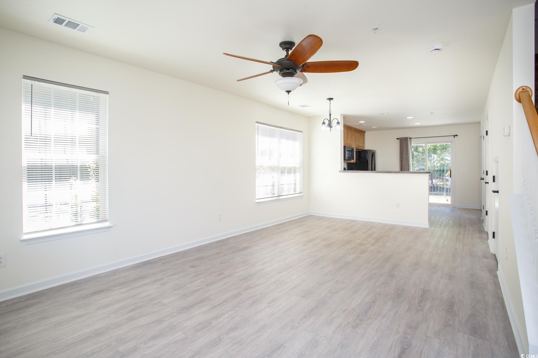 116 Barnacle Lane, Unit 1 Little River, SC 29566 - Photo 3 of 27 Unfurnished living room with light wood finished floors, ceiling fan, and recessed lighting