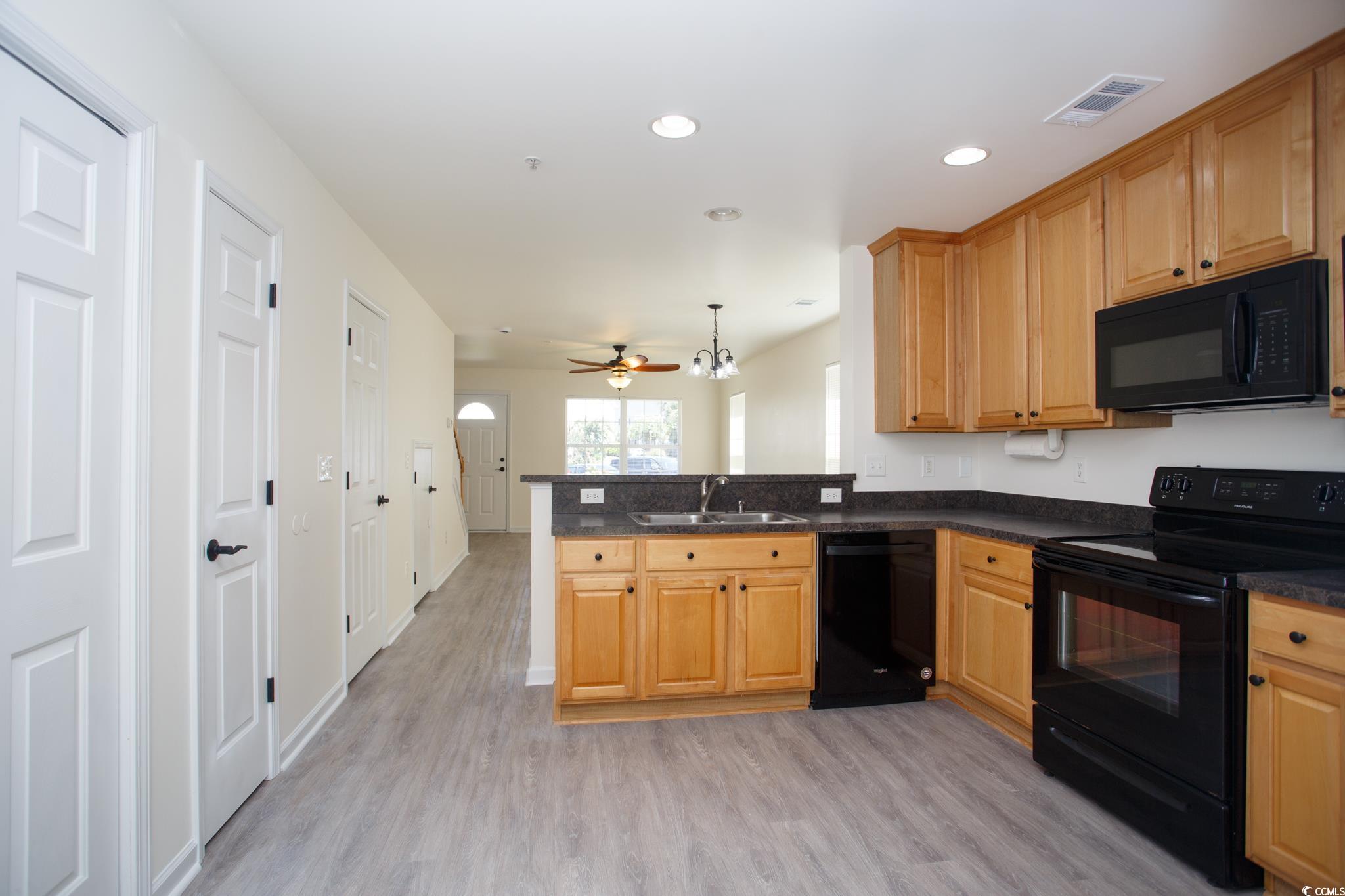 116 Barnacle Lane, Unit 1 Little River, SC 29566 - Photo 8 of 27 Kitchen with black appliances, light wood finished floors, recessed lighting, decorative light fixtures, and ceiling fan