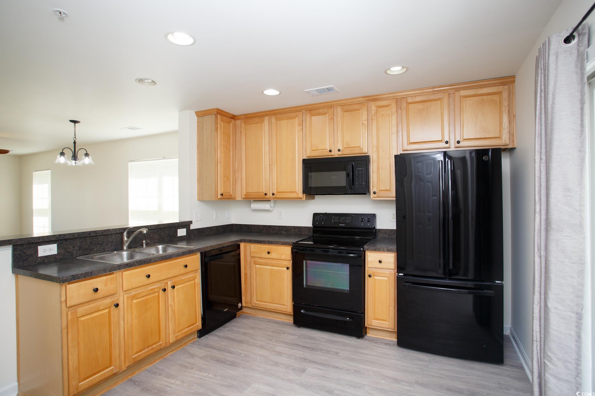 116 Barnacle Lane, Unit 1 Little River, SC 29566 - Photo 9 of 27 Kitchen featuring black appliances, recessed lighting, light wood-style flooring, a chandelier, and dark countertops