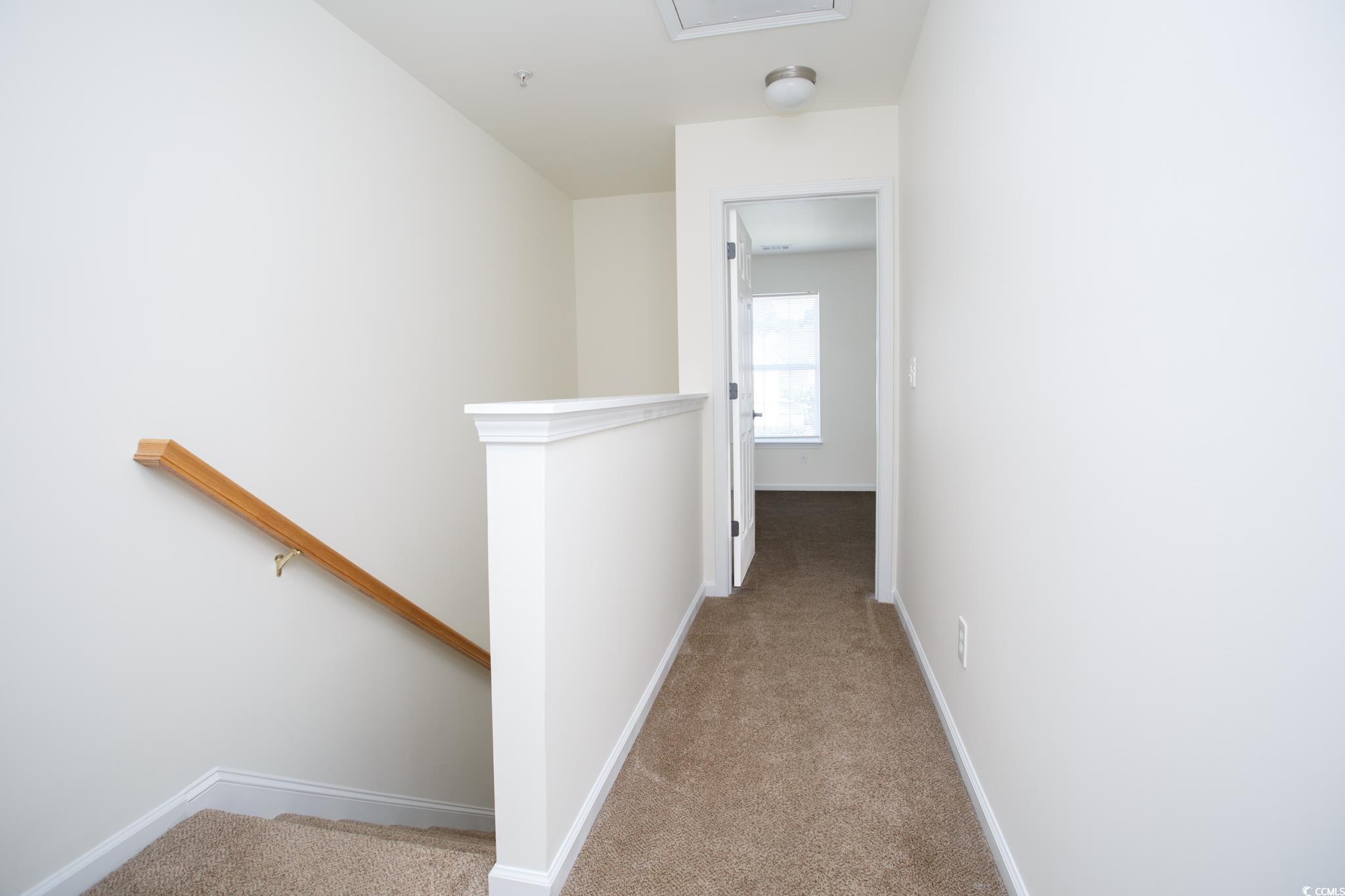 116 Barnacle Lane, Unit 1 Little River, SC 29566 - Photo 10 of 27 Corridor featuring an upstairs landing and light colored carpet