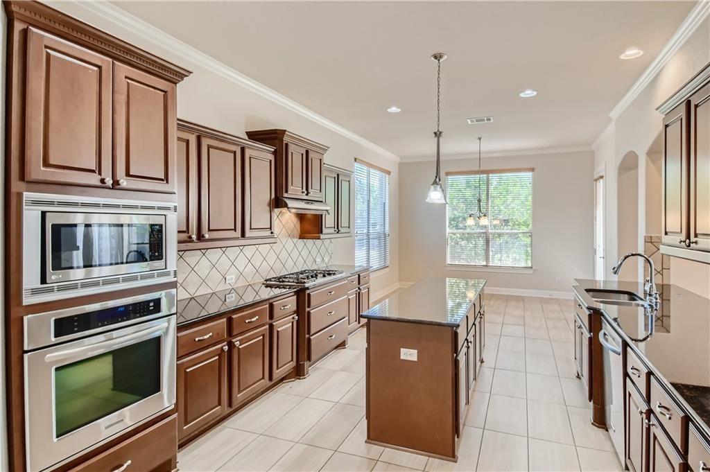 3822 Remington Road Cedar Park, TX 78613 - Photo 11 of 31 a kitchen with stainless steel appliances granite countertop a stove and a sink