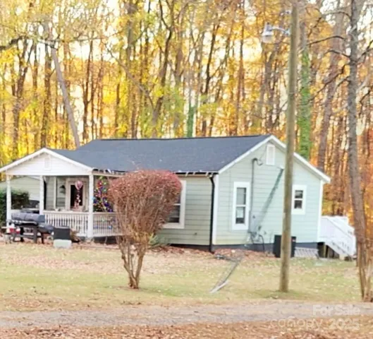 a view of a patio with table and chairs under an umbrella
