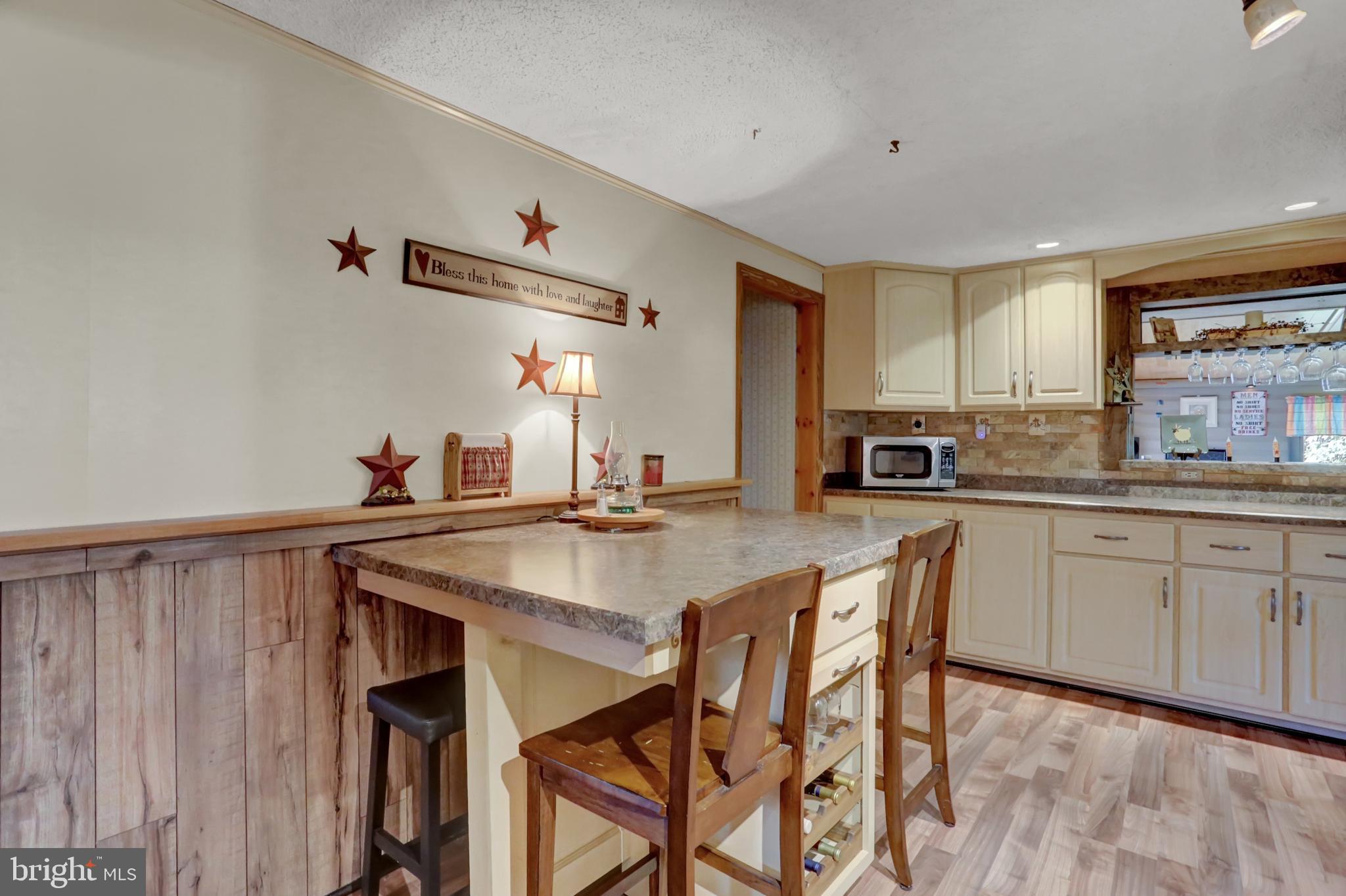 198 Eastbrook Road Smoketown, PA 17602 - Photo 17 of 35 a kitchen with stainless steel appliances kitchen island granite countertop a table chairs sink and cabinets