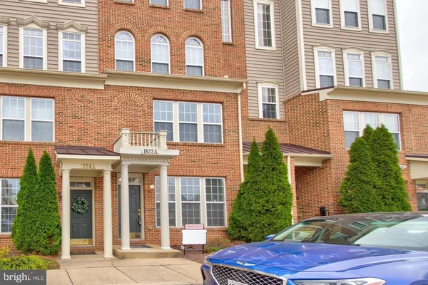 front view of a brick house with a yard