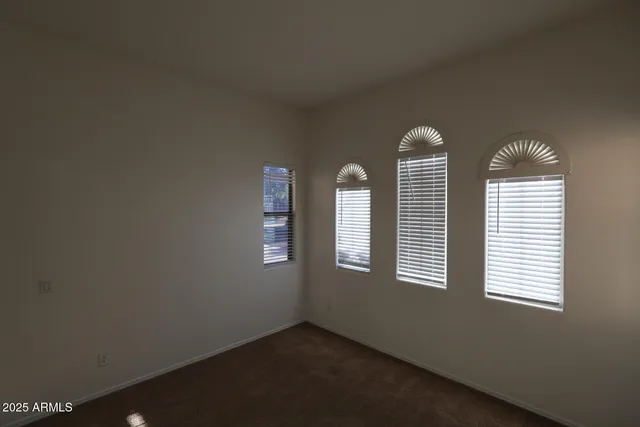 a view of a livingroom with a ceiling fan and window