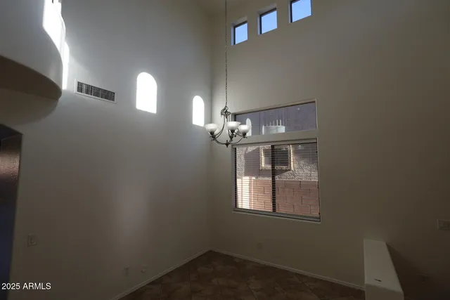 a kitchen with granite countertop wooden cabinets a sink and a window